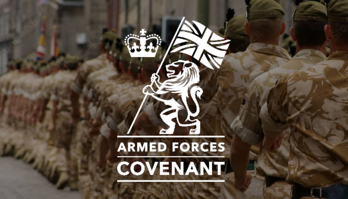An image of soliders marching away from the camera so we can see the back of them. They are in full camo uniform. On top of this image there is the Armed Forces covenant logo which has a crown and a lion holding the Union Jack flag above text.
