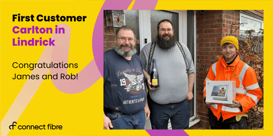 The first customers to be connected in Carlton-in-Lindrick stood next to their front door smiling with a Connect Fibre installation expert