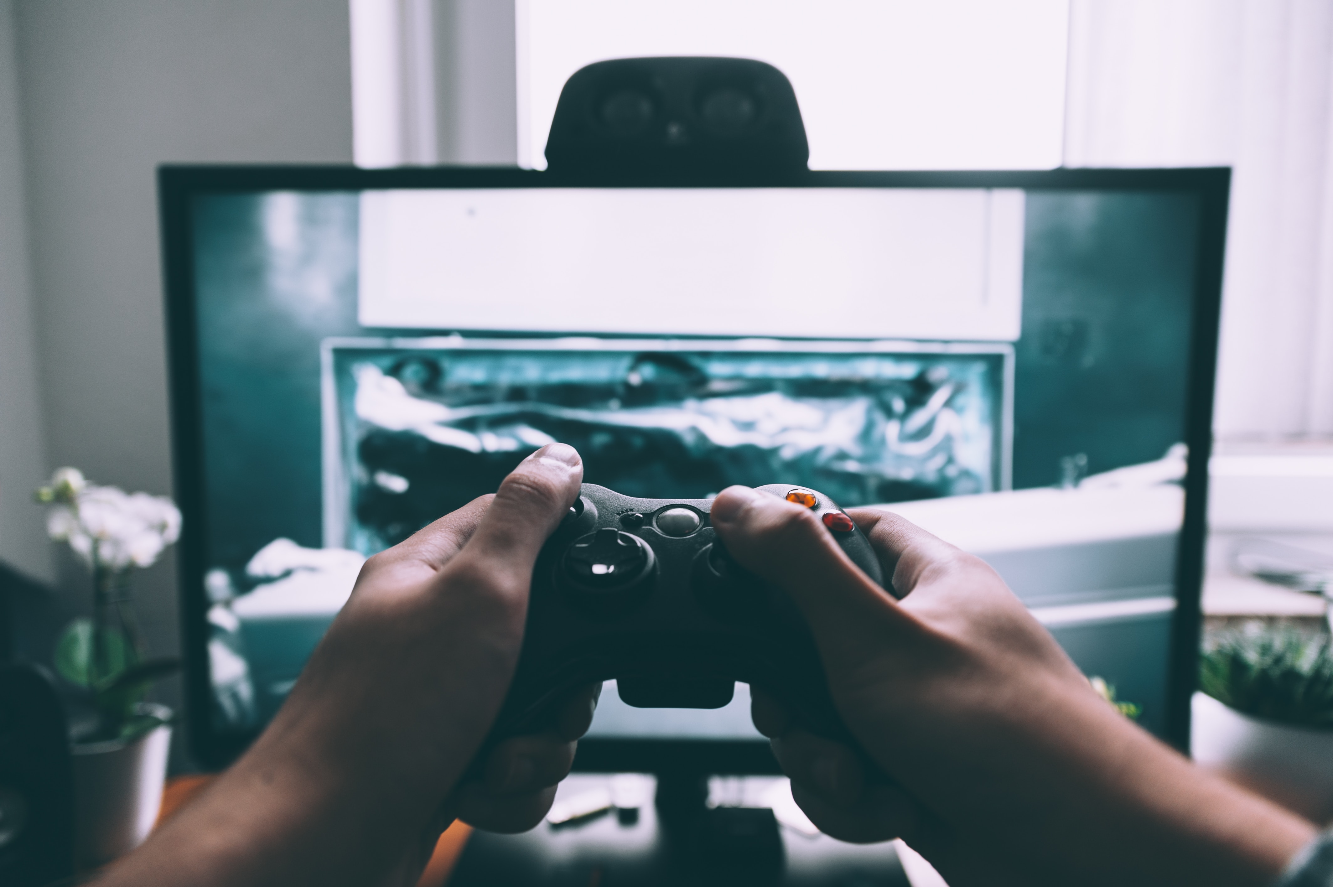 Game controller held infront of a screen